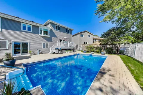 a view of a swimming pool with a patio and a garden