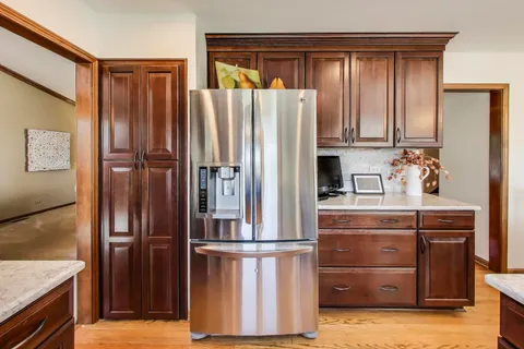 a kitchen with stainless steel appliances a refrigerator and cabinets