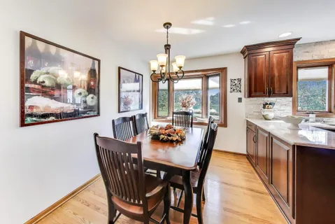 a dining room with furniture a painting and a chandelier
