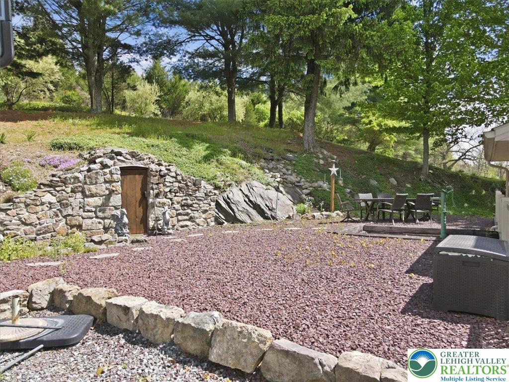 4880 Little Gap Road Kunkletown, PA 18058 - Photo 75 of 100 This charming outdoor area features a unique stone structure nestled into a natural hillside.