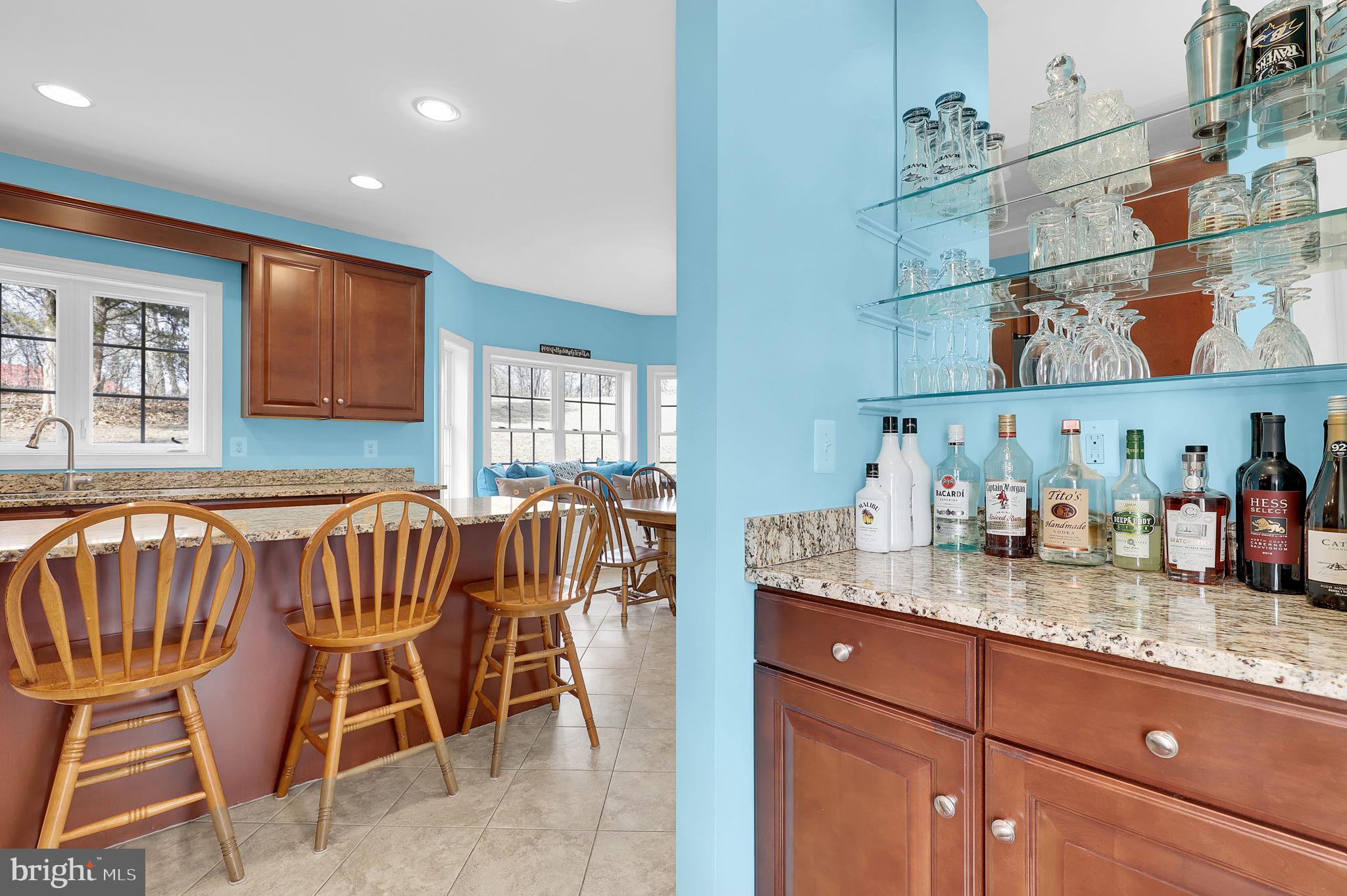 6024 Old Bohn Road Mount Airy, MD 21771 - Photo 12 of 46 a kitchen with granite countertop lots of white furniture and wooden floor