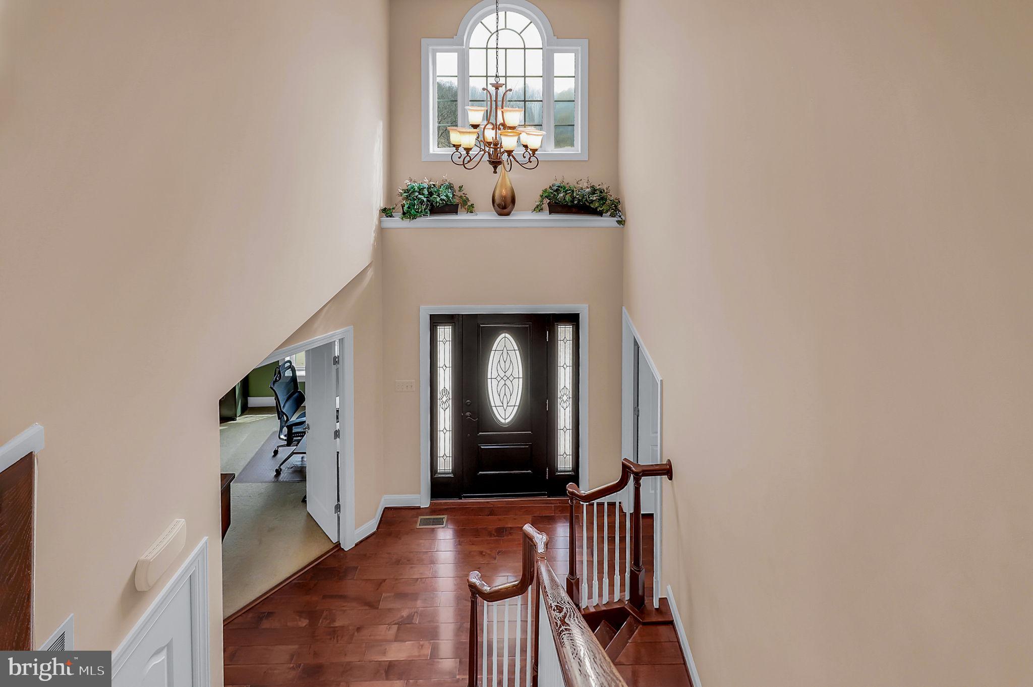 6024 Old Bohn Road Mount Airy, MD 21771 - Photo 25 of 46 a view of a livingroom with wooden floor and a chandelier