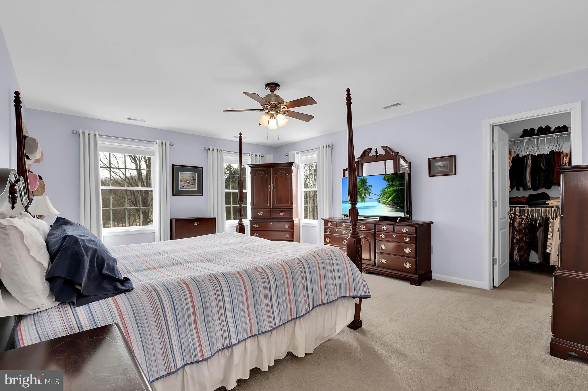 6024 Old Bohn Road Mount Airy, MD 21771 - Photo 29 of 46 a bedroom with a bed a ceiling fan and a flat tv screen
