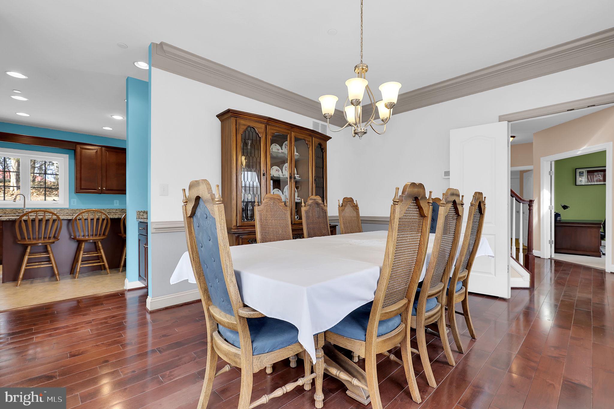6024 Old Bohn Road Mount Airy, MD 21771 - Photo 10 of 46 a view of a dining room with furniture wooden floor and chandelier