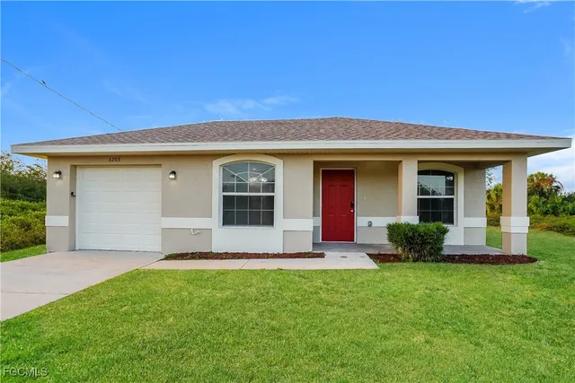 a front view of a house with a yard and porch