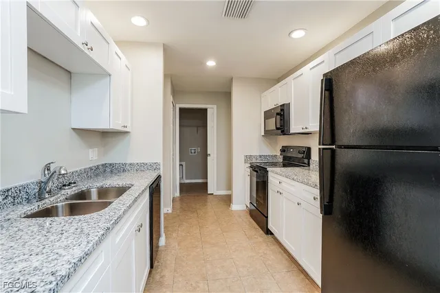 a kitchen with a refrigerator sink and stove
