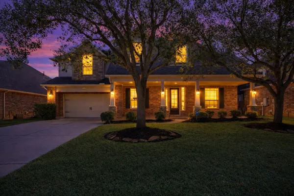 a view of a house with backyard and sitting area
