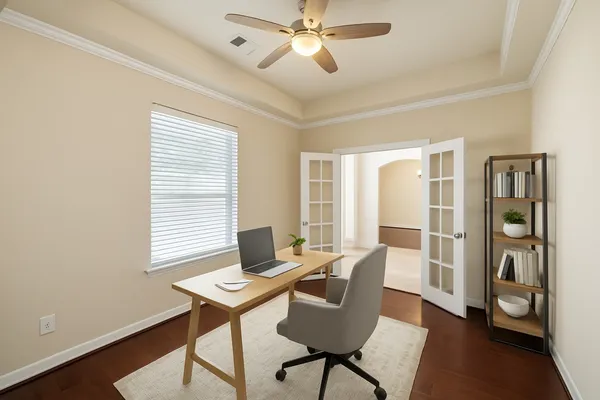 a view of a workspace with furniture and a window