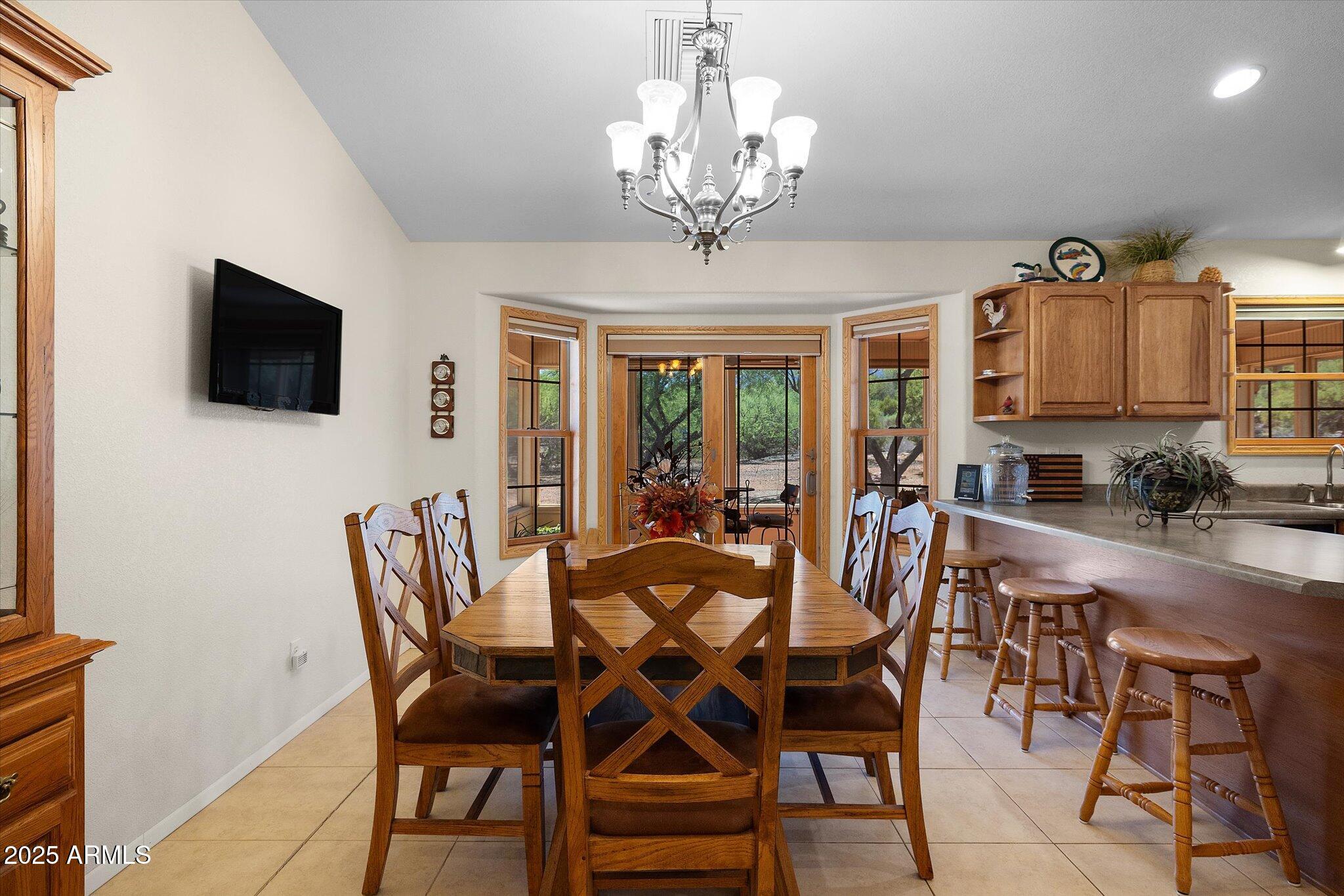 129 West Mt Ord Circle Payson, AZ 85541 - Photo 13 of 40 a view of a dining room with furniture and a chandelier