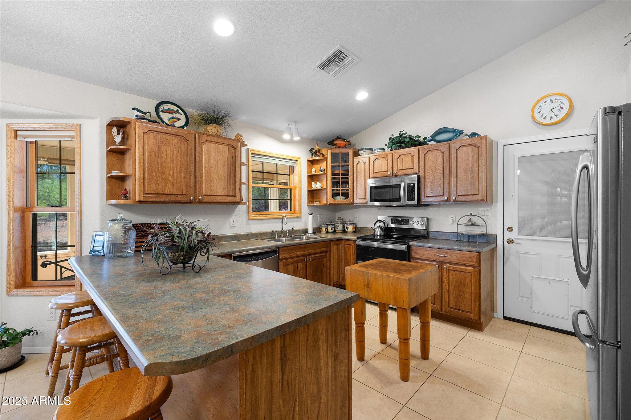 129 West Mt Ord Circle Payson, AZ 85541 - Photo 16 of 40 a kitchen with a refrigerator a stove a sink and a cabinets