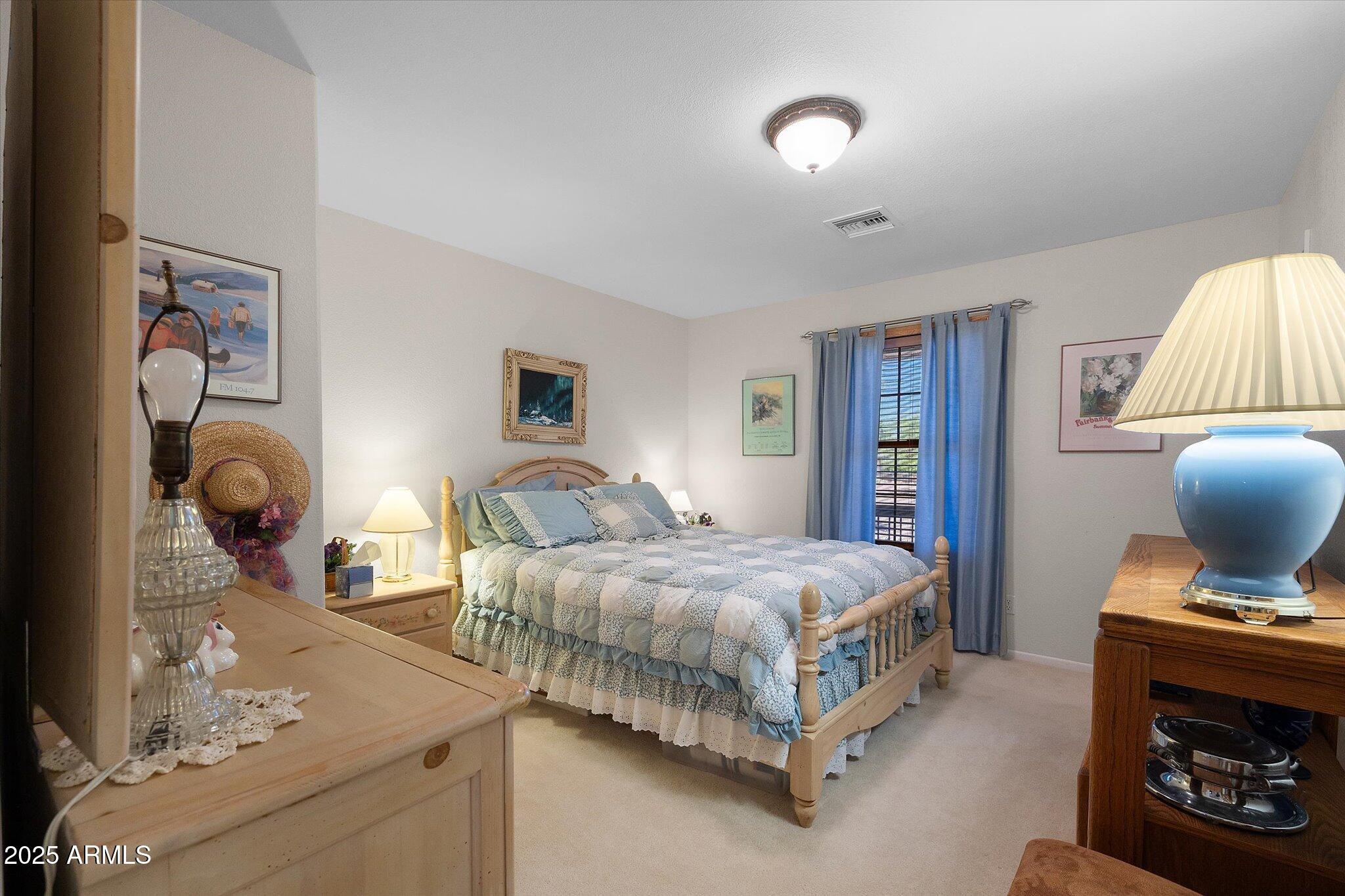 129 West Mt Ord Circle Payson, AZ 85541 - Photo 20 of 40 a bedroom with a bed and wooden floor