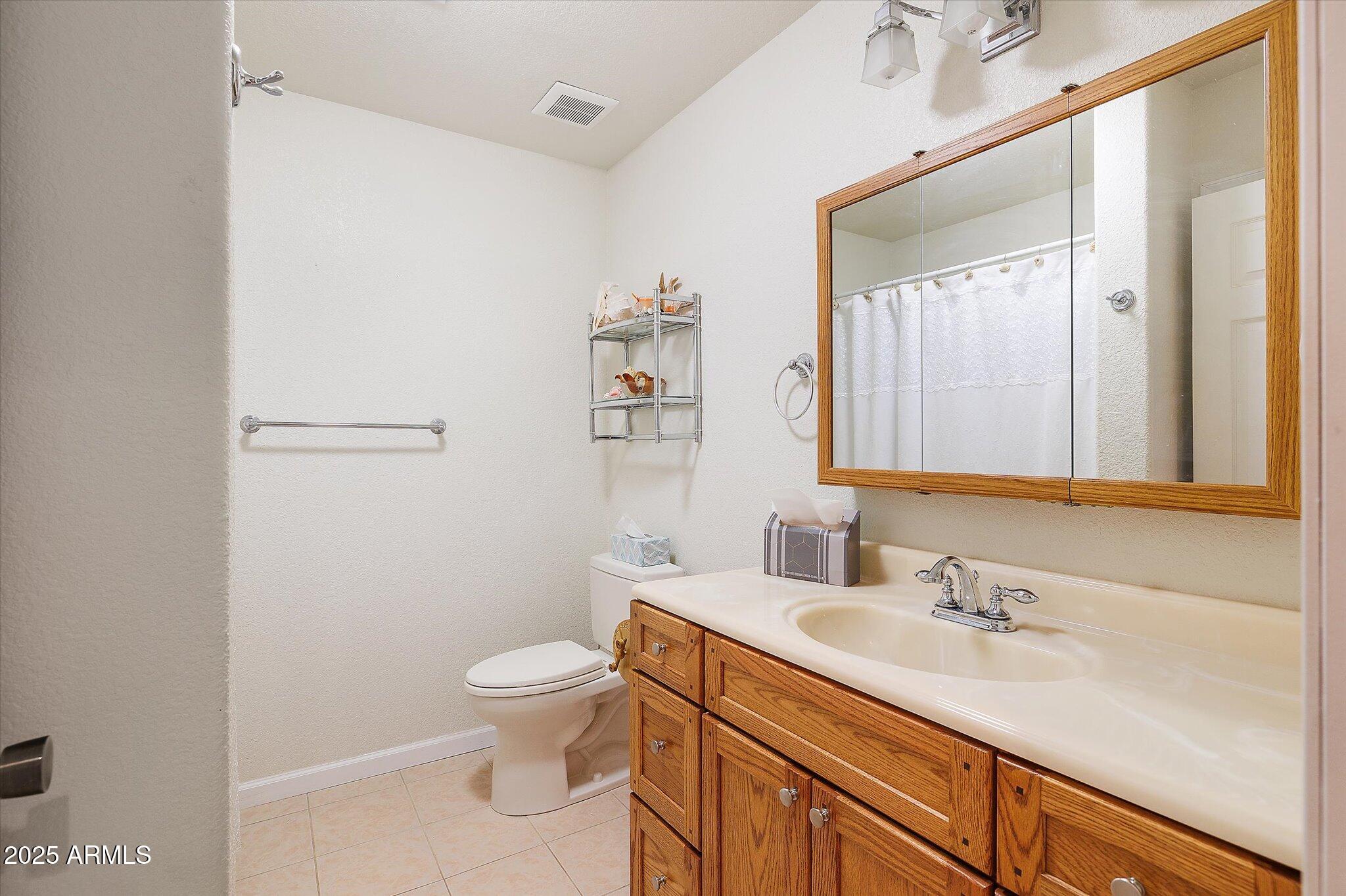 129 West Mt Ord Circle Payson, AZ 85541 - Photo 22 of 40 a bathroom with a sink a toilet and a mirror