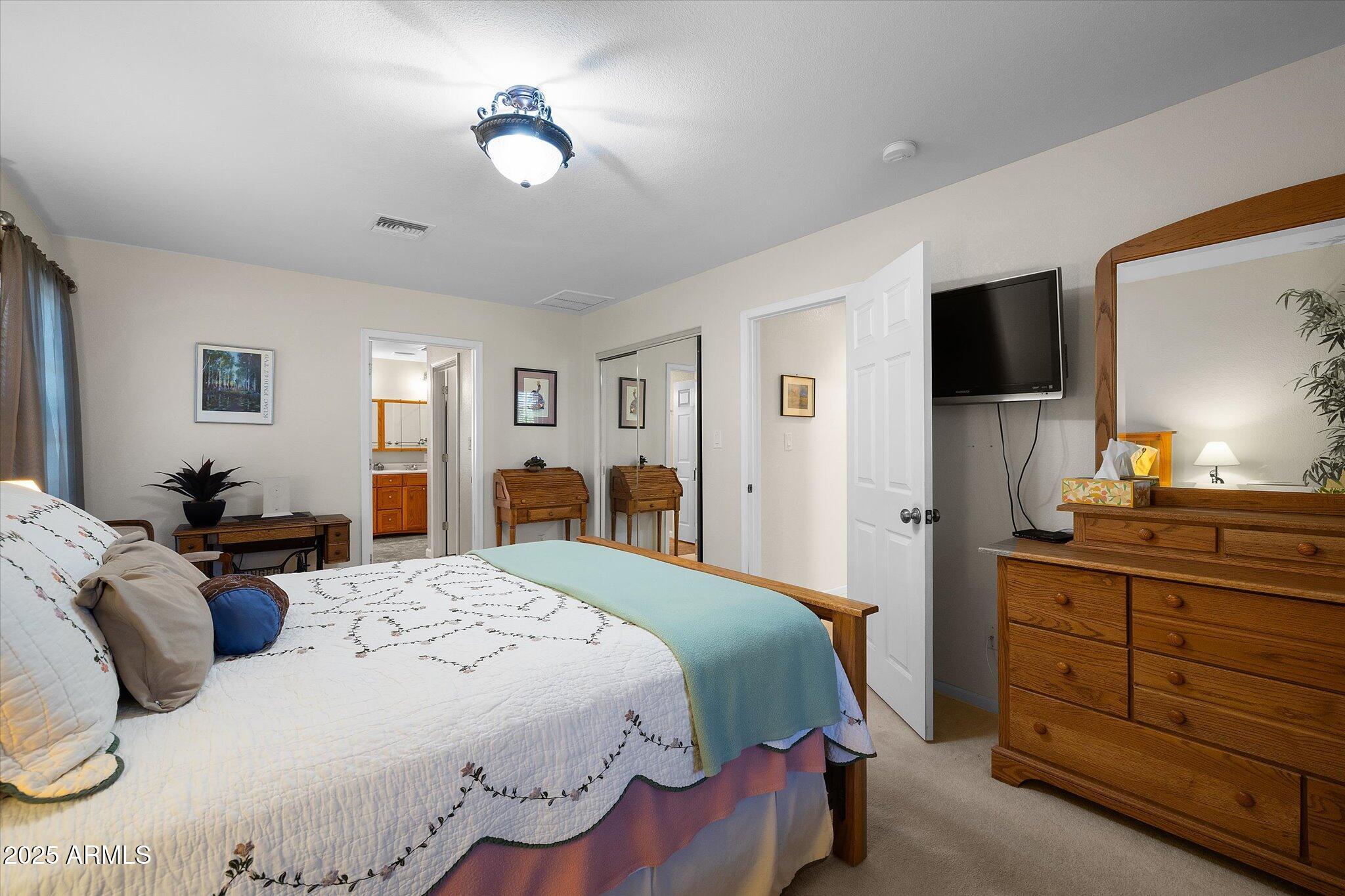 129 West Mt Ord Circle Payson, AZ 85541 - Photo 9 of 40 a bedroom with a bed and a chandelier