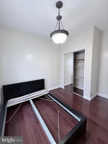 a view of wooden floor and a chandelier in a room