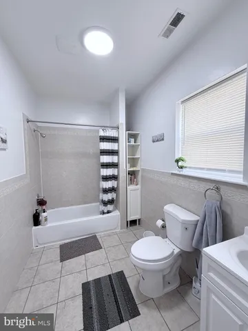 a bathroom with a toilet sink and a mirror