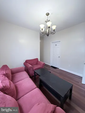 a view of a room with chairs and wooden floor