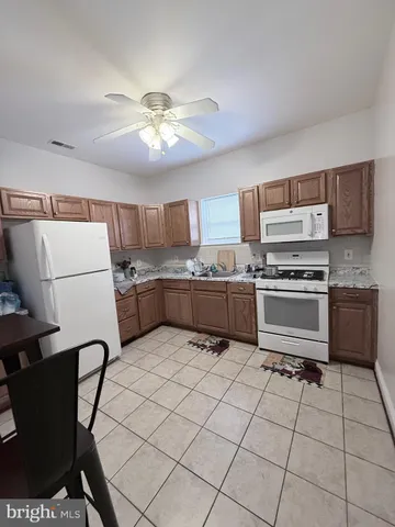 a kitchen with a cabinets a sink and a stove top oven