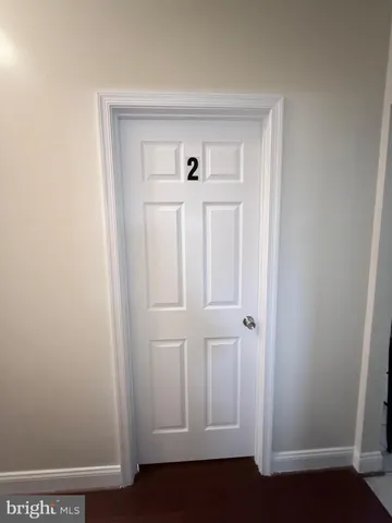 an empty room with wooden floor and closet