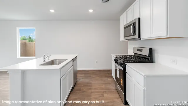 a kitchen with stainless steel appliances granite countertop a stove and a microwave