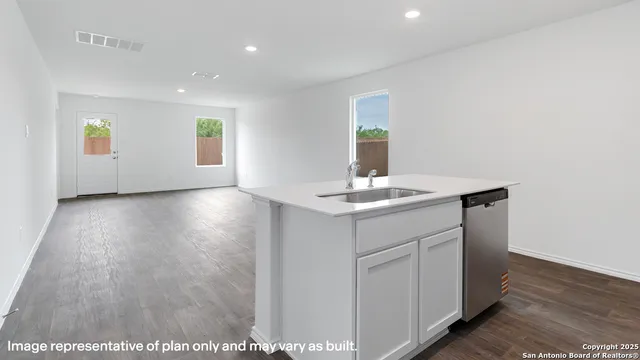 a view of a kitchen with a sink and dishwasher