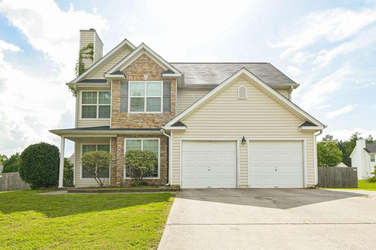 65 Ridge Pointe Drive, Unit 95 Covington, GA 30016 - Photo 1 of 1 a front view of a house with a yard