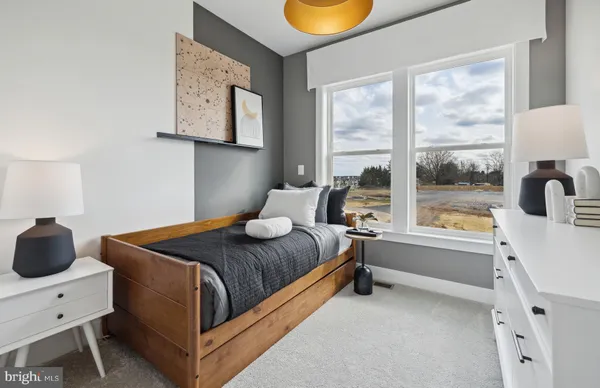 a bedroom with a bed and window