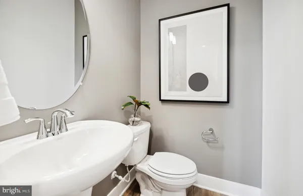 a bathroom with a toilet a sink and mirror