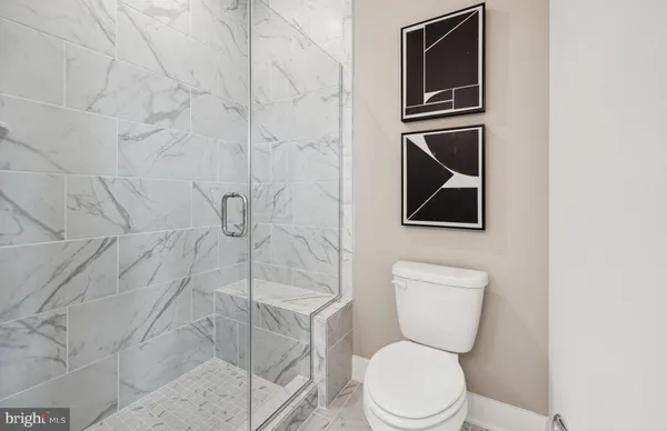 a white toilet sitting next to a bathroom