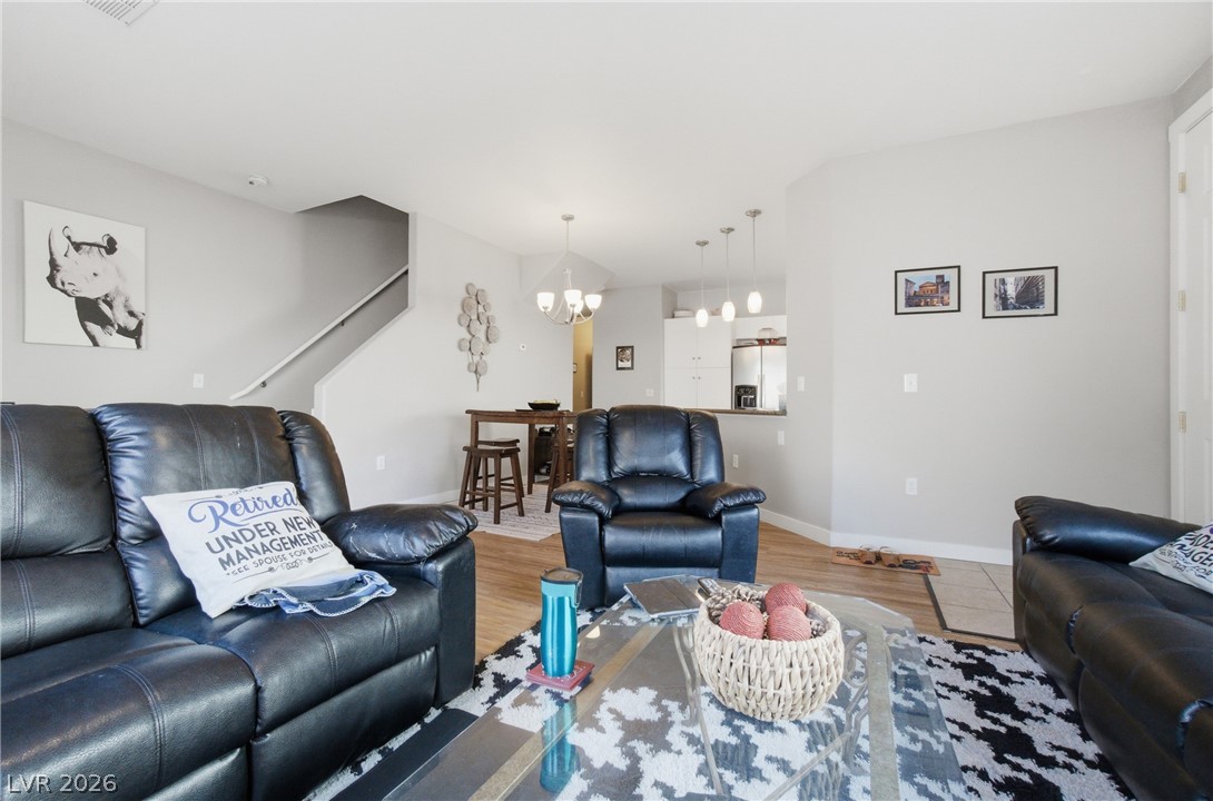 6316 Snap Ridge Street, Unit 101 North Las Vegas, NV 89081 - Photo 10 of 41 Spacious and well-lit, the living room provides direct access to the private backyard through a large sliding glass door. A functional layout allows for flexible furniture arrangement and easy indoor-outdoor living.