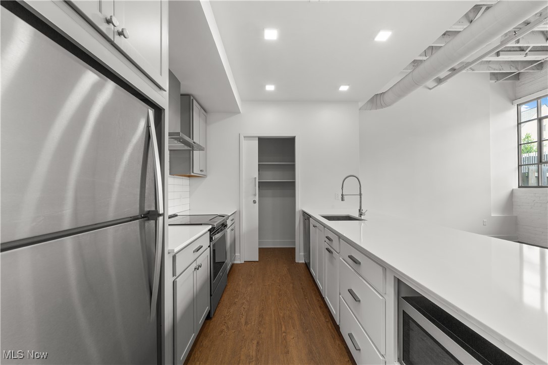 2048 Fulton Road, Unit 107 Cleveland, OH 44113 - Photo 27 of 37 Kitchen with a tucked away microwave and pantry storage