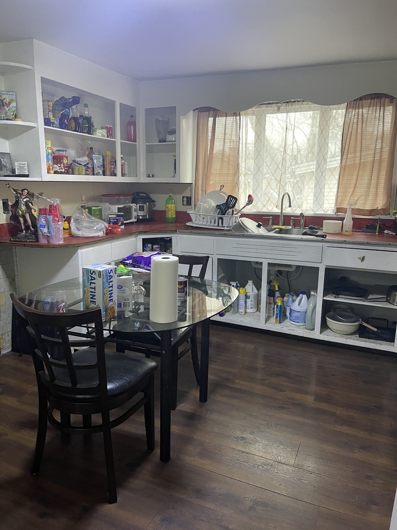 263 Beach Street Aurora, IL 60505 - Photo 5 of 6 a dining room with stainless steel appliances a table and chairs in it