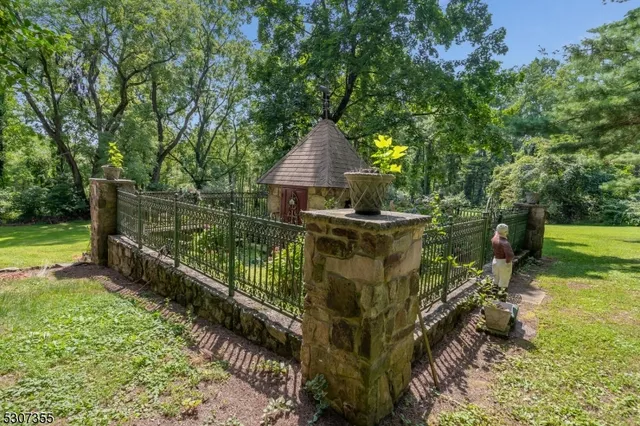 a view of a garden with wooden fence