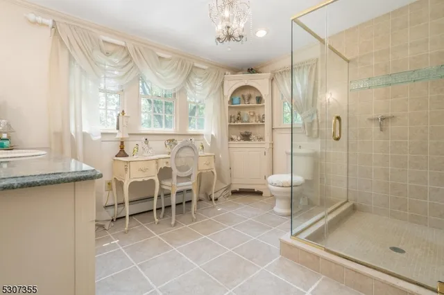 a spacious bathroom with a shower and a sink a mirror