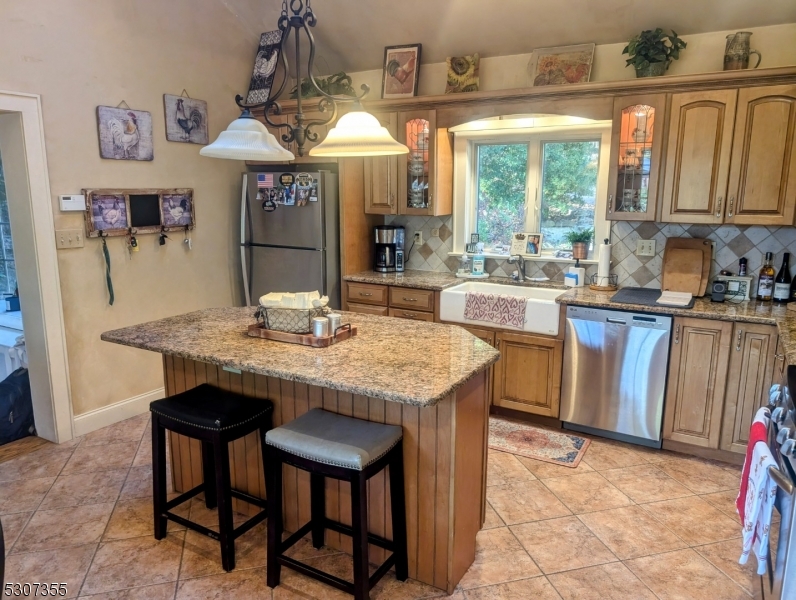 1 Dove Hollow Lane Hampton, NJ 08827 - Photo 35 of 49 a kitchen with stainless steel appliances granite countertop table chairs and a large window