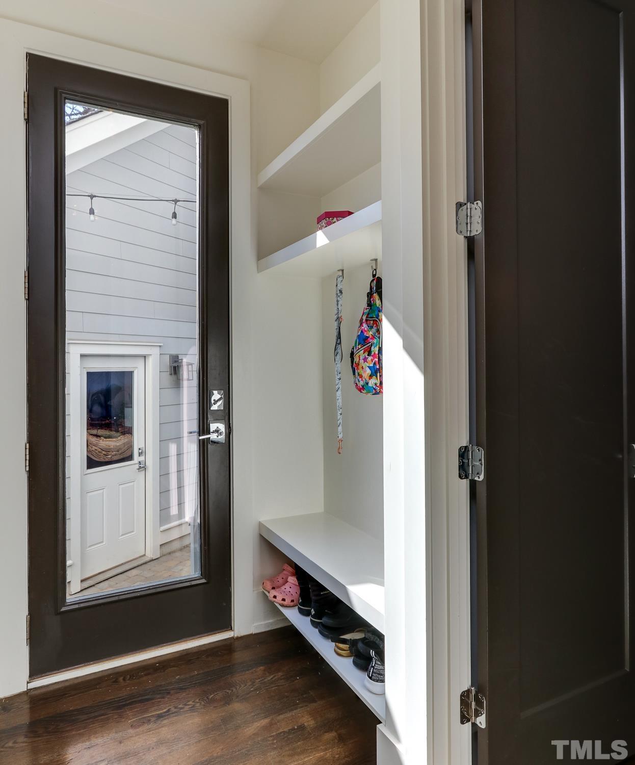 107 Revival Way Raleigh, NC 27608 - Photo 11 of 31 an entryway with wooden floor and cabinet