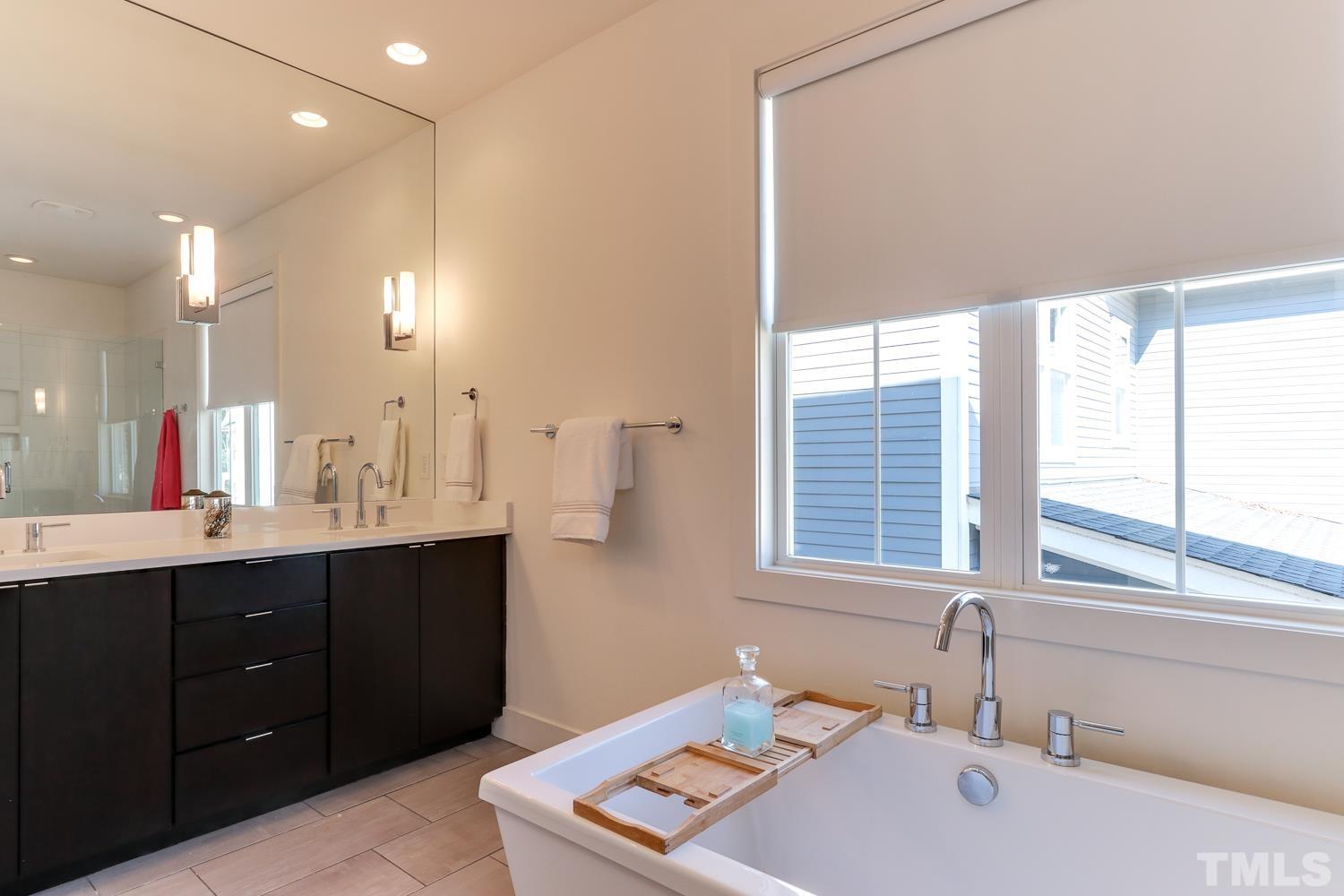 107 Revival Way Raleigh, NC 27608 - Photo 15 of 31 a bathroom with a tub sink and mirror