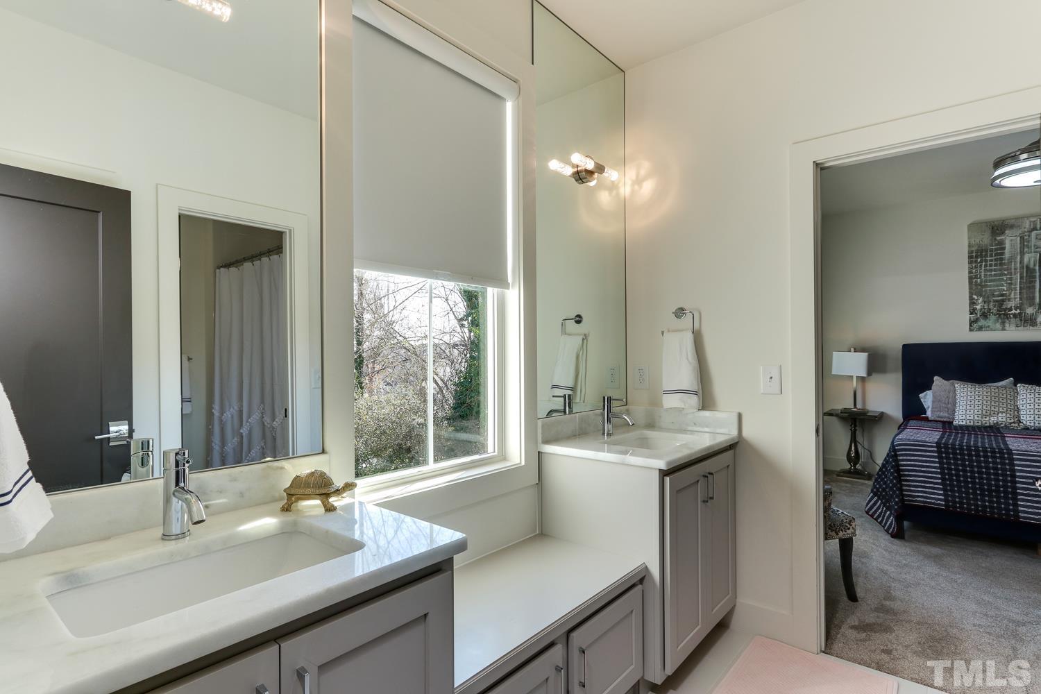 107 Revival Way Raleigh, NC 27608 - Photo 18 of 31 a en suite bathroom with a sink and a mirror