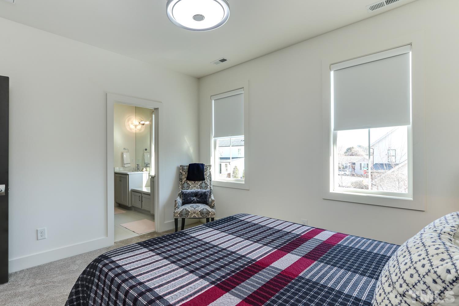 107 Revival Way Raleigh, NC 27608 - Photo 20 of 31 a bedroom with a bed and wooden floor