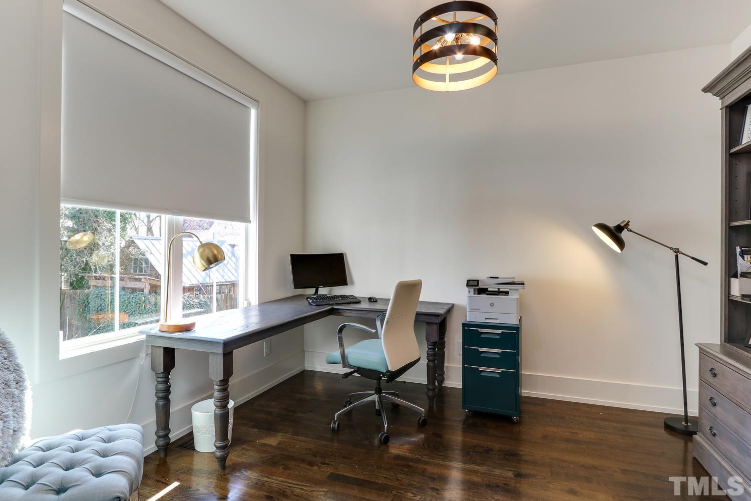107 Revival Way Raleigh, NC 27608 - Photo 4 of 31 a view of a workspace with furniture and a window