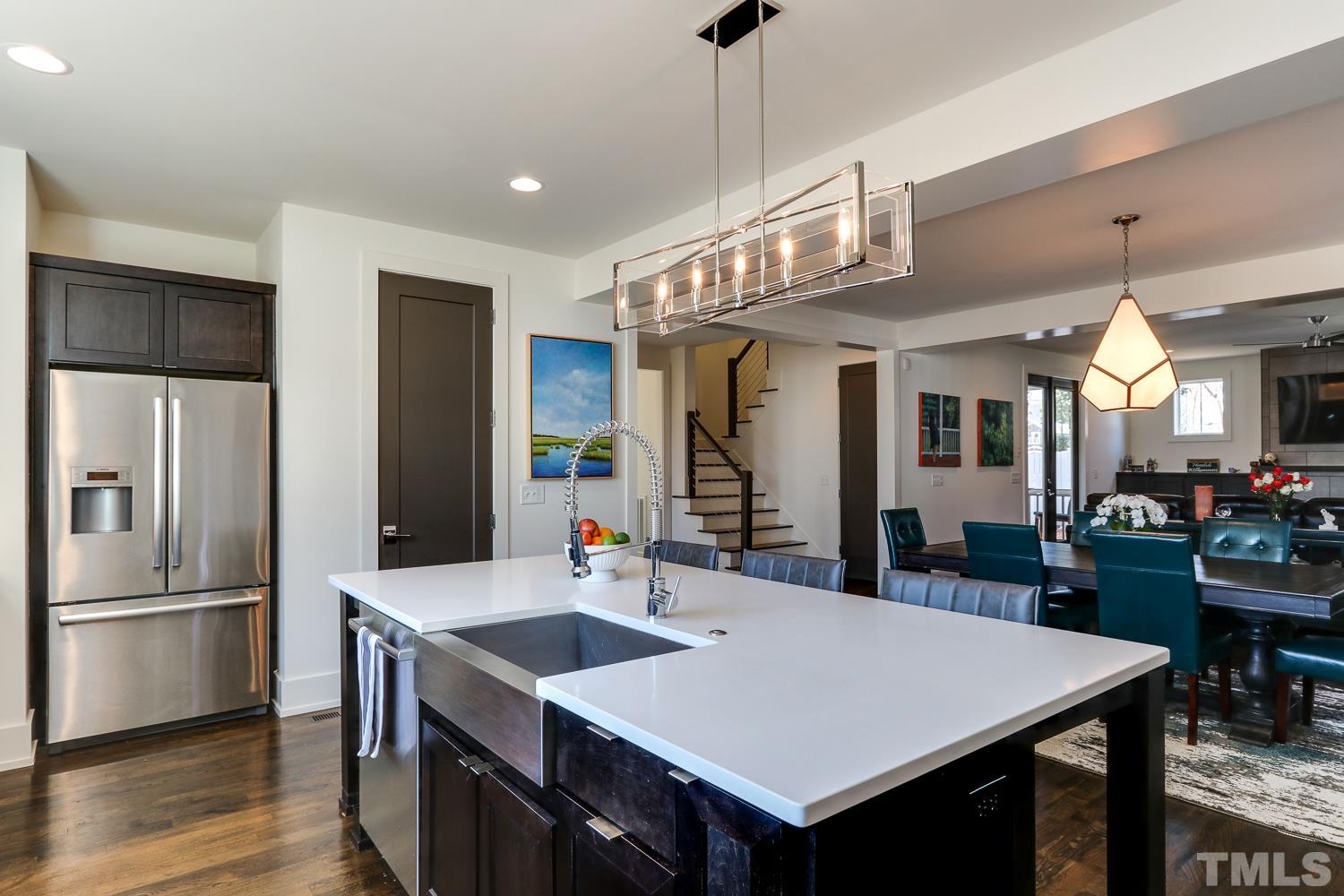 107 Revival Way Raleigh, NC 27608 - Photo 10 of 31 a large kitchen with a table and chairs