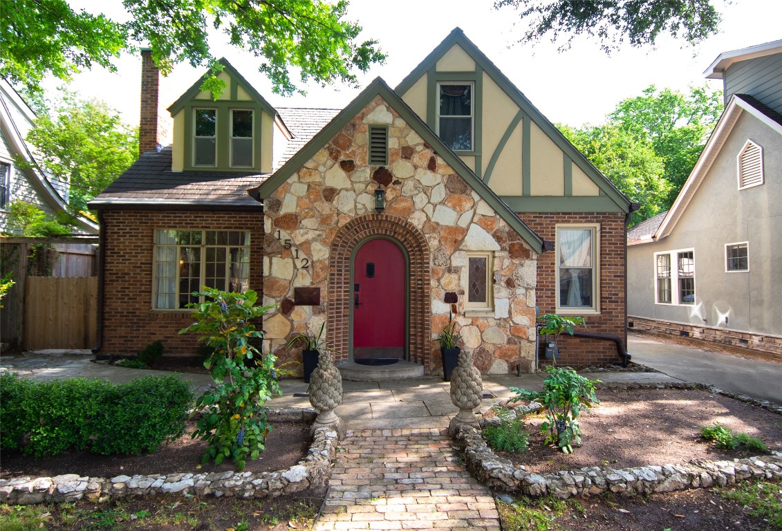 1512 Northwood Road Austin, TX 78703 - Photo 1 of 24 English style home with stone siding, brick siding, and a chimney