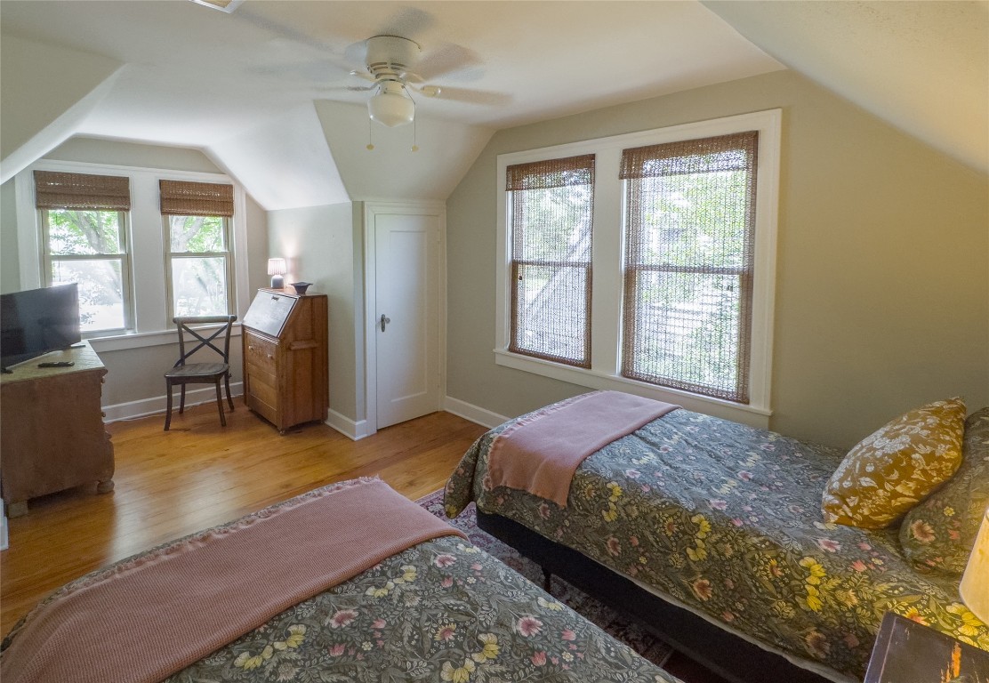 1512 Northwood Road Austin, TX 78703 - Photo 11 of 24 Bedroom featuring vaulted ceiling, light wood-type flooring, and ceiling fan