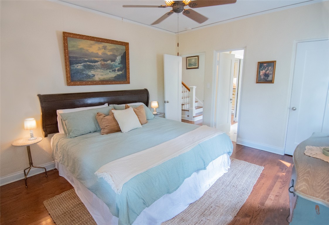 1512 Northwood Road Austin, TX 78703 - Photo 8 of 24 Bedroom with crown molding, wood finished floors, and a ceiling fan