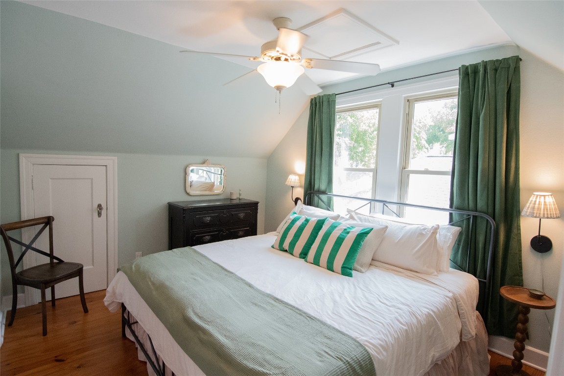 1512 Northwood Road Austin, TX 78703 - Photo 9 of 24 Bedroom with lofted ceiling, dark wood-type flooring, and a ceiling fan