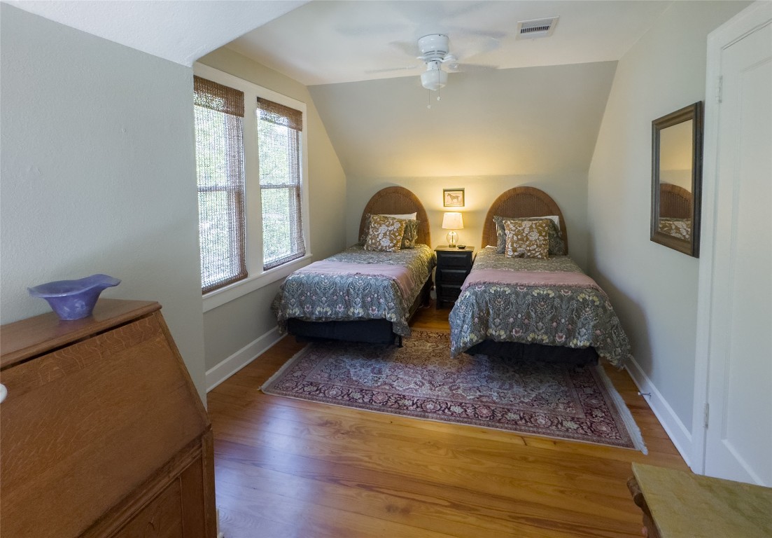 1512 Northwood Road Austin, TX 78703 - Photo 10 of 24 Bedroom featuring vaulted ceiling, wood finished floors, and a ceiling fan