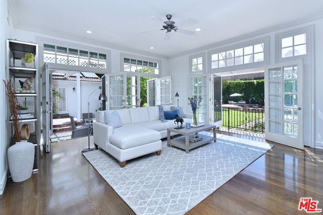 a bedroom with a bed a table and flat screen tv