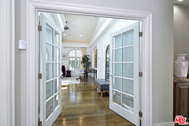 a bedroom with a bed a table and painting on the wall