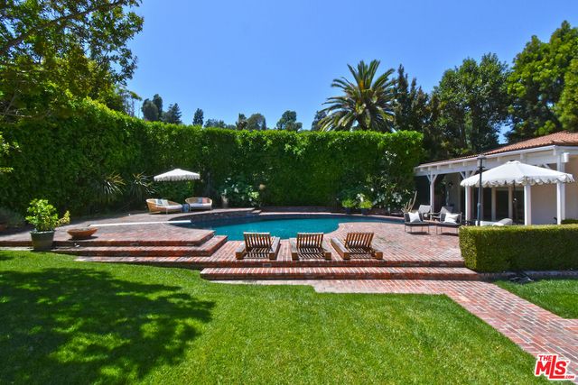 a view of an house with backyard space and sitting area