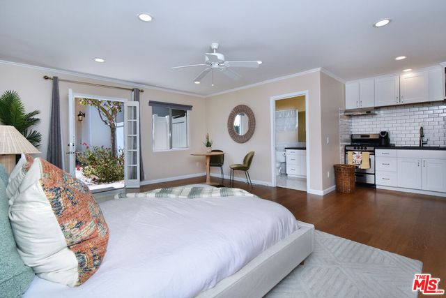 a front view of a house with garden and sitting area