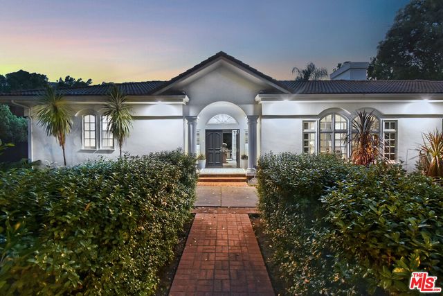 a view of a dining room with furniture a chandelier and wooden floor